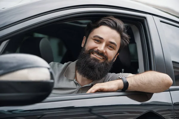 Young man smiling while driving a car — Stock Photo, Image