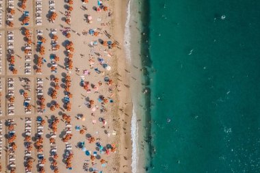 Aerial view of people resting on the beach near the sea clipart