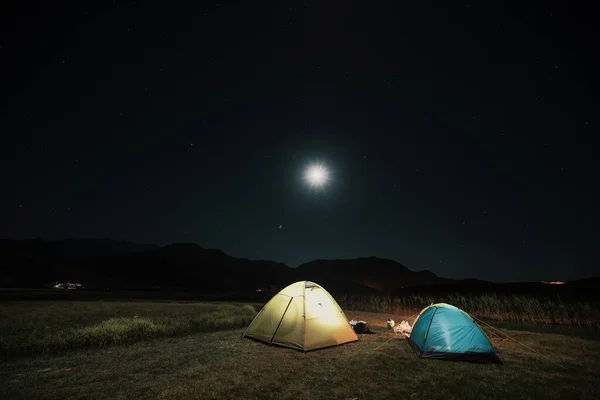 Tourist tents in camp among meadow in the night mountains — Stock Photo, Image