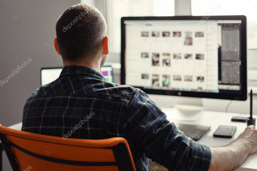 Modern man working remotely on a computer from home office