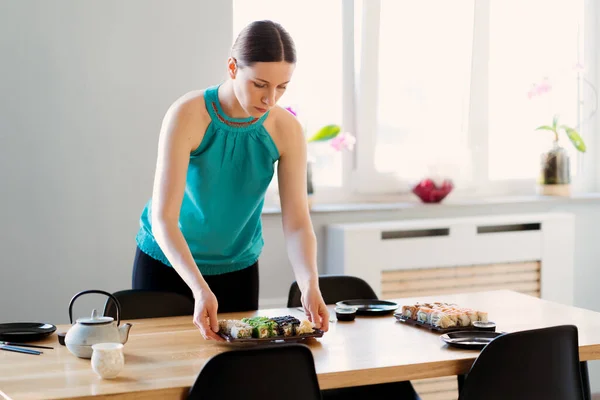 Mulher bonita preparando uma festa de sushi para seus amigos — Fotografia de Stock