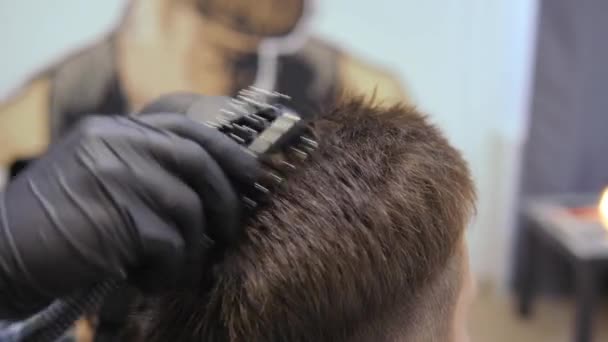 Hairdresser for men. Barbershop. Caring for the beard. Barber with hair clipper works on hairstyle for bearded guy barbershop background. Hipster lifestyle concept. Barber with clipper trimming hair — Stock Video