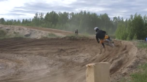 Junho 10, 2018 Federação Russa, região de Bryansk, Ivot - Esportes radicais, cross motocross. O motociclista entra na curva na pista de corrida. A terra está a voar debaixo das rodas. A máquina — Vídeo de Stock