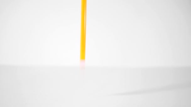 Penna på en vit bakgrund. Färga pennor faller på vit bakgrund i slow motion — Stockvideo