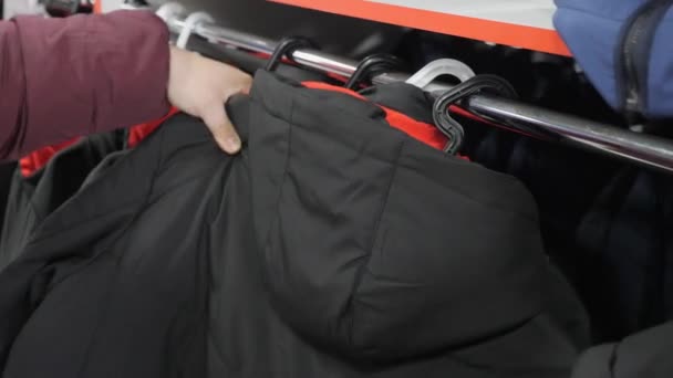 Clothes Hanging Neatly Hangers Female Hand Chooses Outerwear Jacket — Stock Video