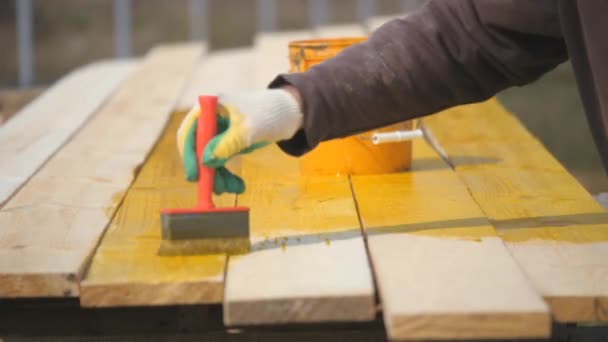 Covering wooden planks with antiseptic. — Stock Video