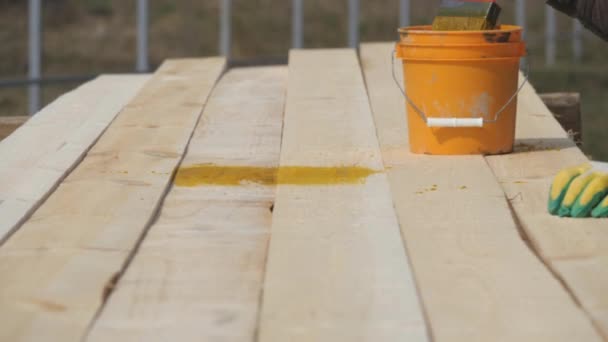 Covering wooden planks with antiseptic. — Stock Video
