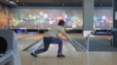 Bowling 'de zaman geçirmek. Pistte paten yapan toplar lobutları devirmek için..