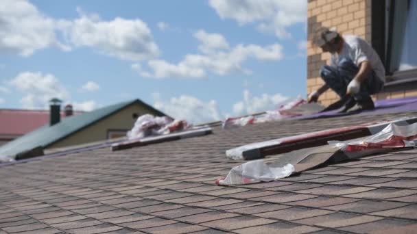 Roofing work. Laying a soft roof on the roof of a private house. — Stock Footage Roofing work. Laying a soft roof on the roof of a private house. Video Clip
