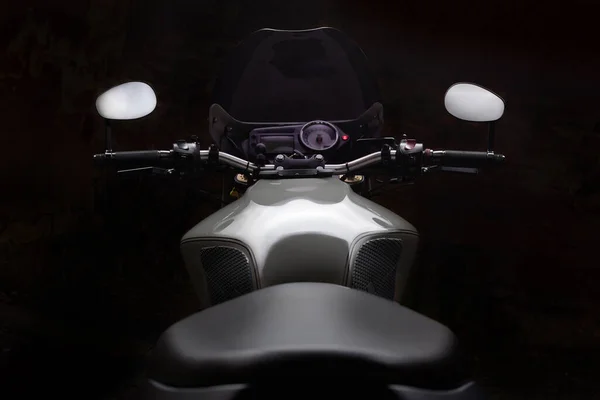 Custom caferacer motorbike on dark background with its headlight on. — Stock Photo, Image