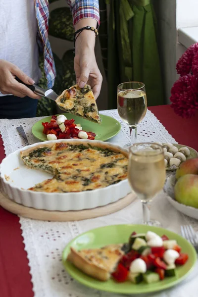 A gourmet lunch: spinach pie with cheese, a bowl of fruits, a sa — Stock Photo, Image