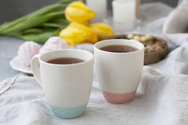 Смачна закуска: дві чашки чаю, тарілка зефіру і коробка з — стокове фото