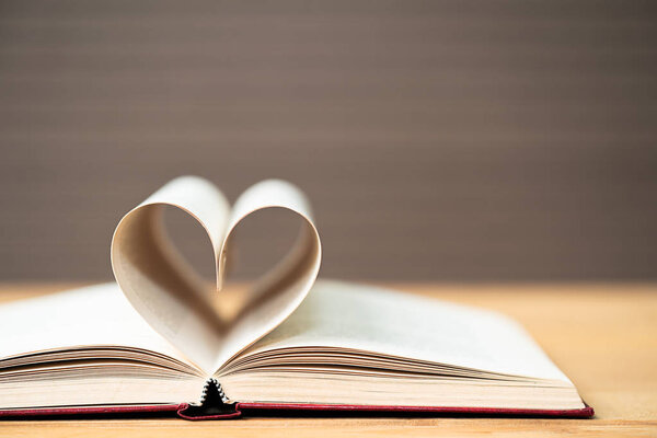 Pages of book curved into a heart shape ,Love concept of heart shape from book pages