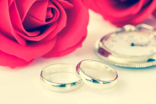 Close up red rose and wedding ring on white background, Wedding concept with roses and ring