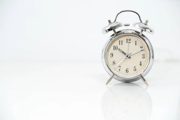 Reloj despertador de plata en blanco —  Fotos de Stock