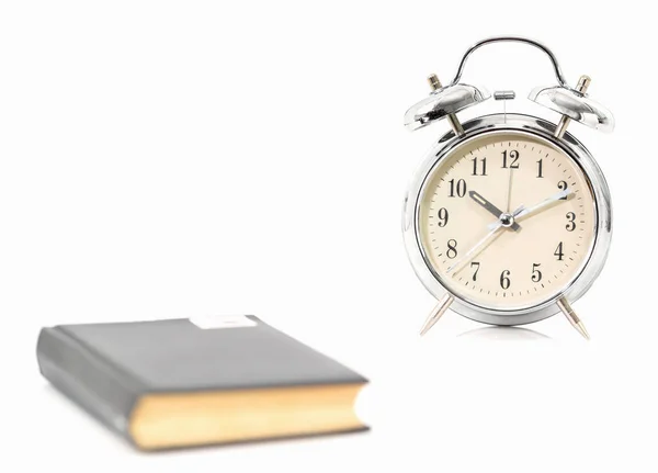 Silver alarm clock and old book — Stock Photo, Image