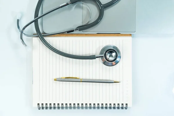 Medical stethoscope for doctor checkup on notepad as medical concept
