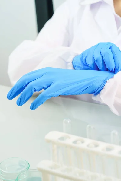 Close Scientist Hands Putting Nitrile Blue Latex Gloves Labcoat Wearing — Stock Photo, Image