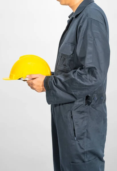 Worker Standing Blue Coverall Holding Yellow Hardhat Isolated Gray Background — Stock Photo, Image