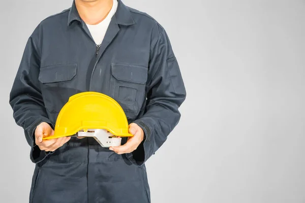 Cloes Trabalhador Macacão Azul Segurando Chapéu Amarelo Isolado Fundo Cinza — Fotografia de Stock