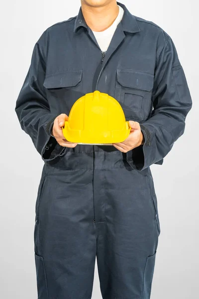 Worker Standing Blue Coverall Holding Yellow Hardhat Isolated Gray Background — Stock Photo, Image