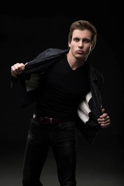 Charming man in black jeanswear shot in the dark — Stock Photo, Image