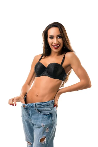 Happy girl in black bra and jeans isolated shot — Stock Photo, Image