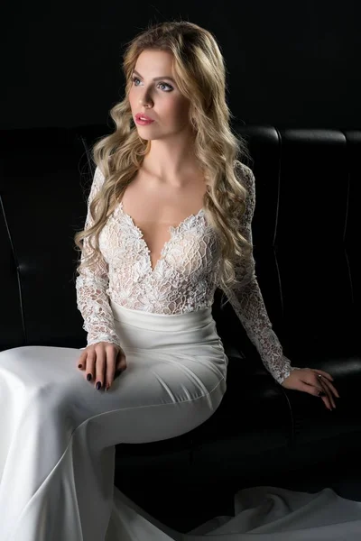 Pretty girl in an evening lace dress on the sofa — Stock Photo, Image