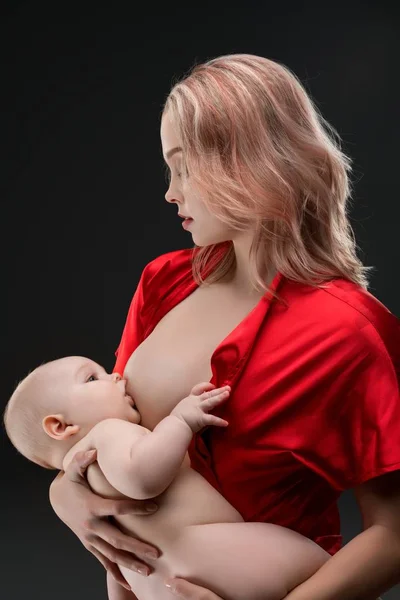 Pretty mother breastfeeding her baby shot — Stock Photo, Image