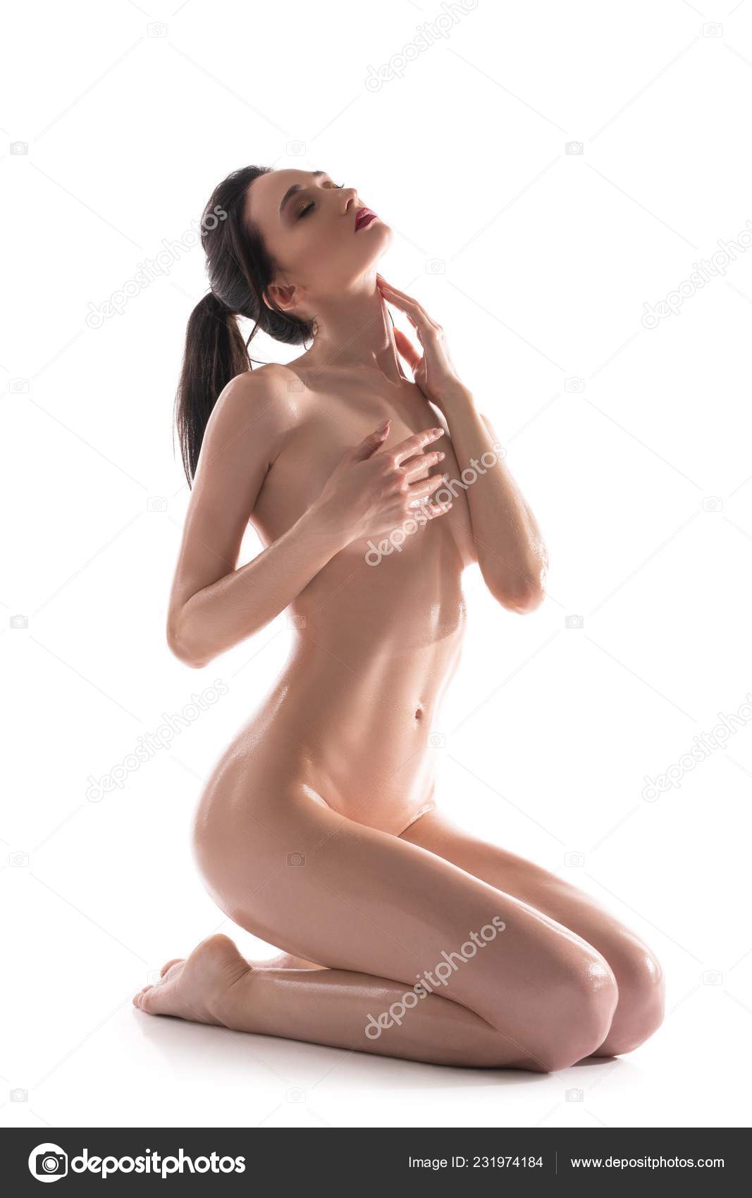 Nude brunette sitting on her knees isolated shot Stock Photo by ©Wisky  231974184