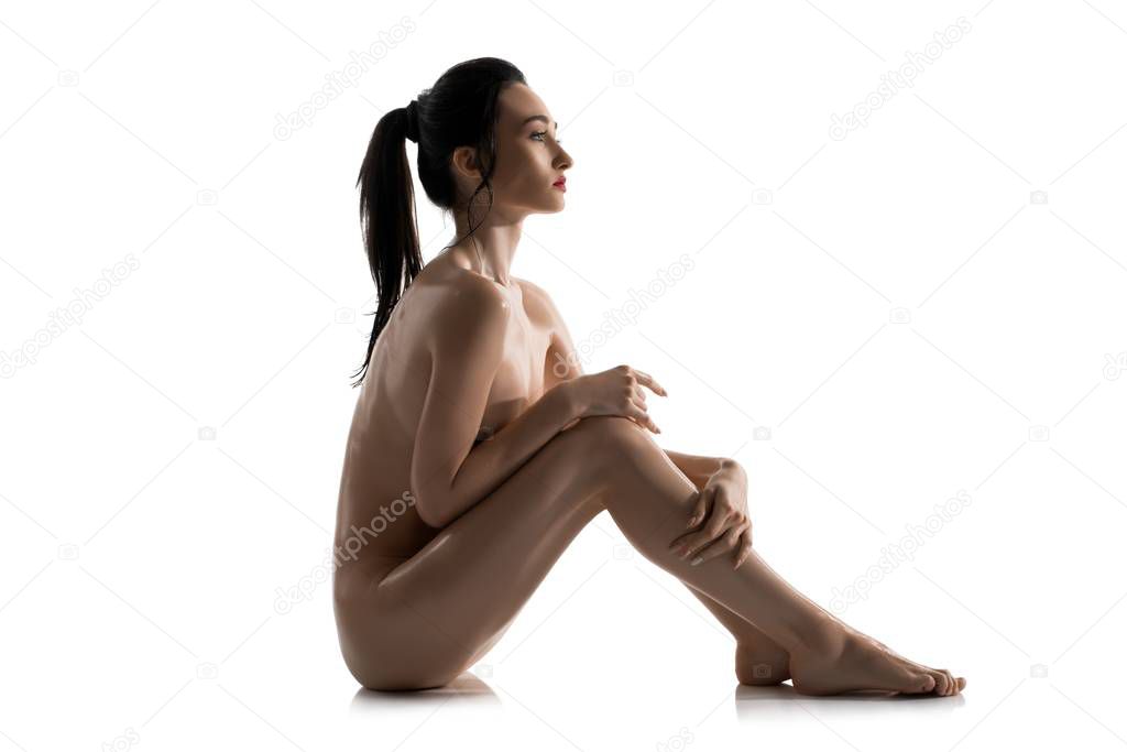 Nude brunette on the floor isolated profile view