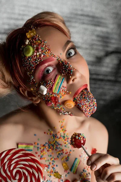 Girl with sweets and caramel on her face shot — Stock Photo, Image