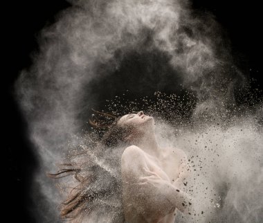 Beyaz toz bulutu içinde belgili tanımlık karanlık çıplak kadın