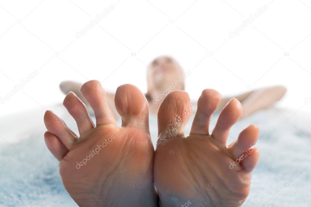 Girl in bath her feet in close up view