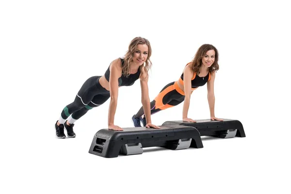 Girls doing fitness on step platform isolated shot — Stock Photo, Image