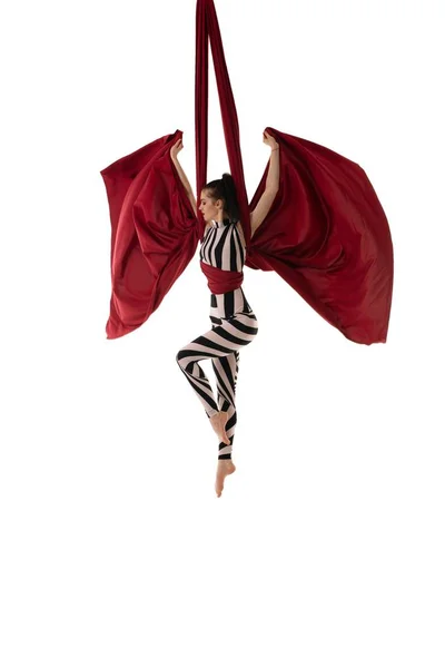 Gymnast in striped body hanging on cloth — Stock Photo, Image