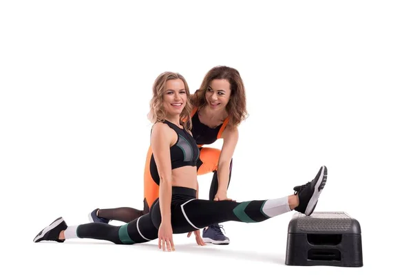 Two slim girls in sportswear doing fitness view — Stock Photo, Image