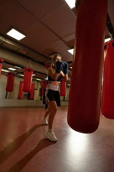 Молодая блондинка в боксёрских перчатках в спортзале — стоковое фото