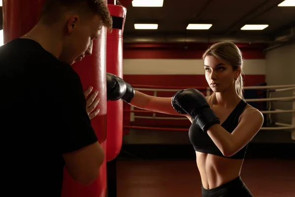 Boxer working out with trainer in gym — Stock Photo, Image