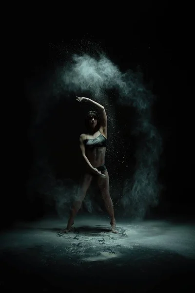 Graceful girl dancing in white dust cloud view — Stock Photo, Image