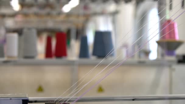 Spools of color thread on knitting machine view — Stock Video