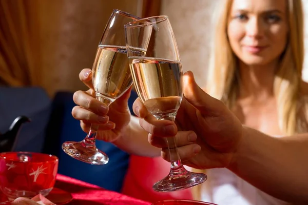 People raising glasses with drink and clinking