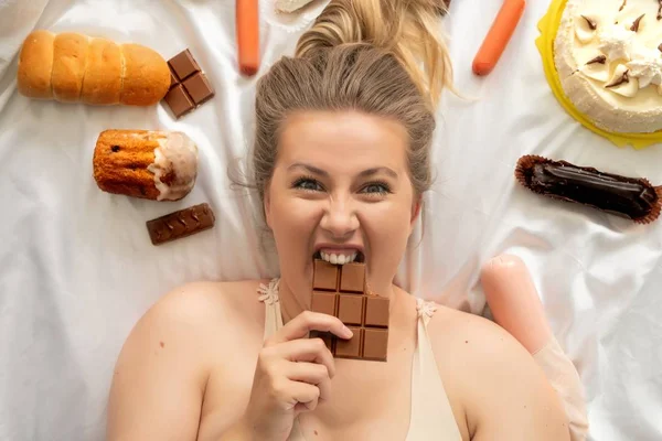 Fat blonde with dessert doing fitness shot