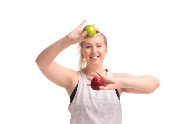 Hauska lihava tyttö urheiluvaatteet omenat ammuttu — kuvapankkivalokuva