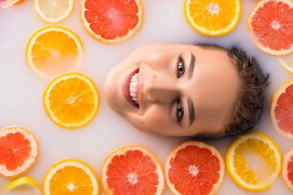 Charming smiling woman taking spa citrus bath — Stock Photo, Image