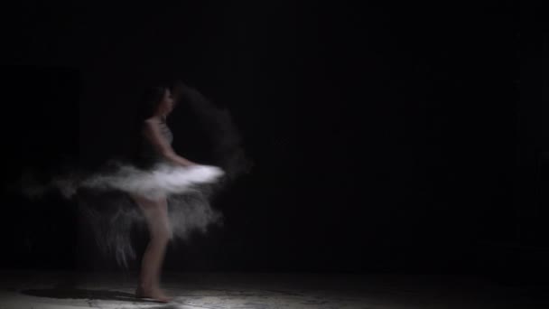 Slim κορίτσι στο σώμα πετάει σκόνη στο σκοτάδι — Αρχείο Βίντεο