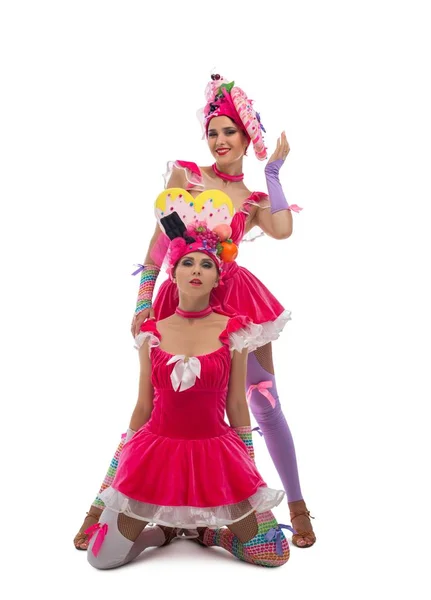 Playful dancers in original hats and dresses view — Stock Photo, Image