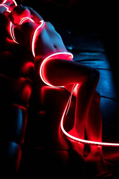 Naakte vrouw verpakt in LEDs hoge hoek schot — Stockfoto