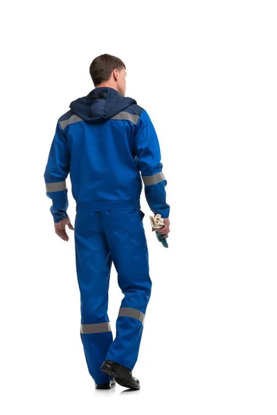 Man in blauw werkkleren geïsoleerd achteruitkijk — Stockfoto