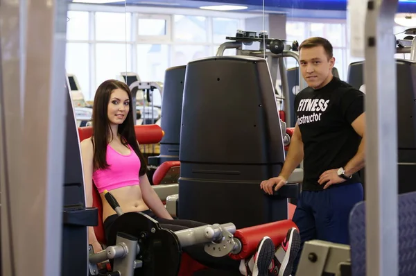 Spor salonunda. Fitness Eğitmeni ve kız kameraya poz — Stok fotoğraf